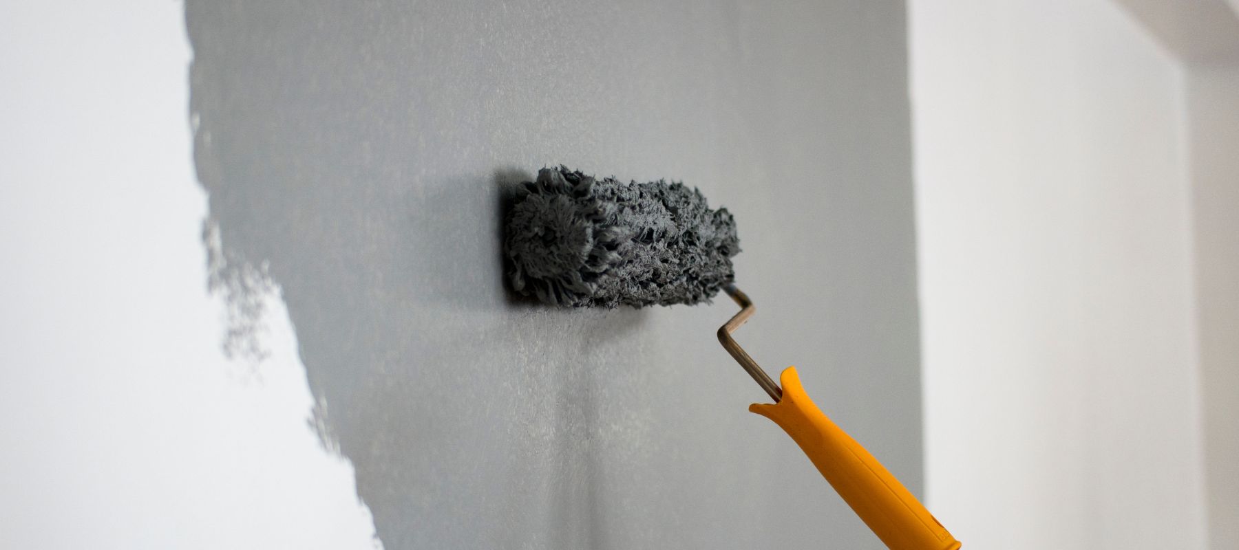 using a textured roller to paint a wall grey