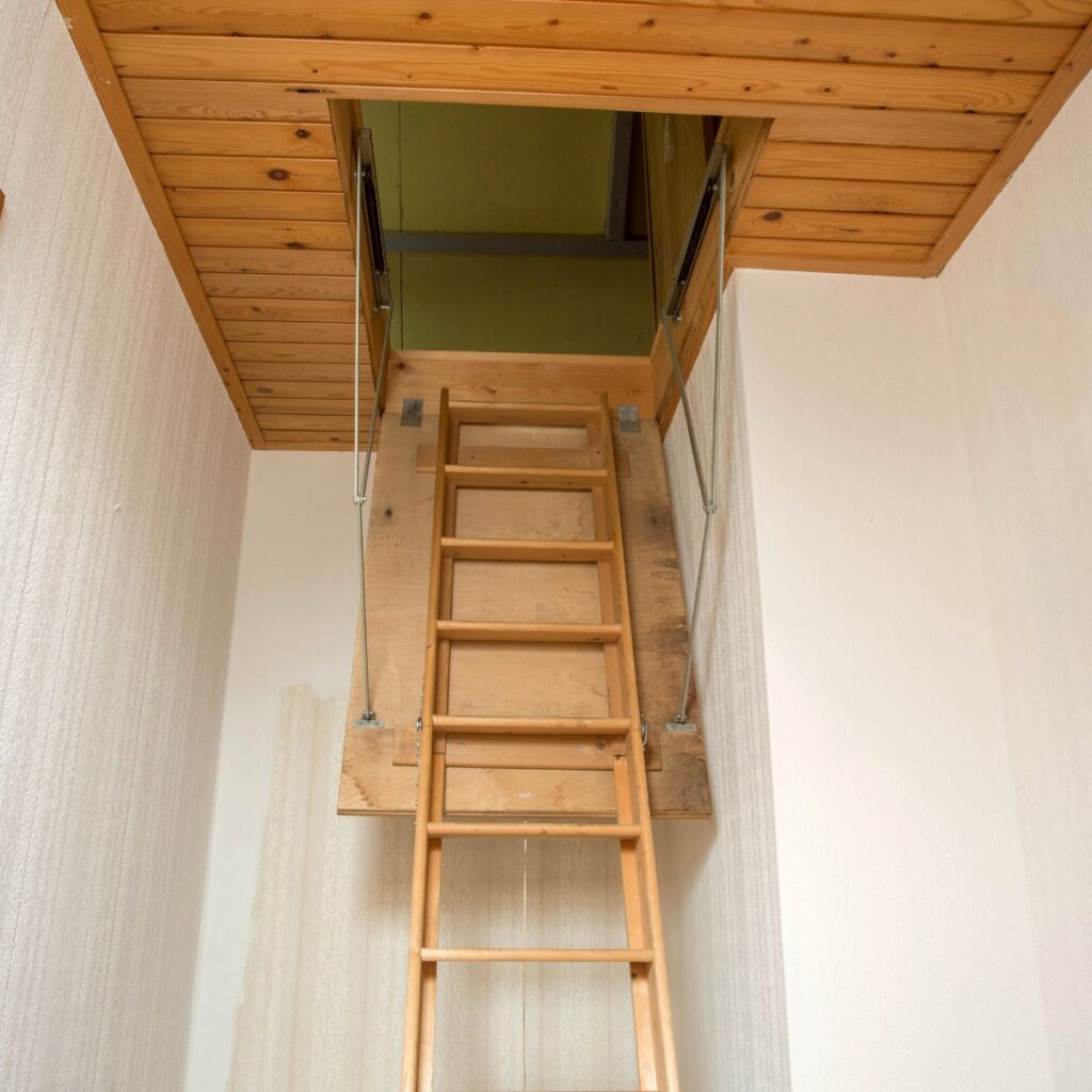 closeup of a attic ladder leading up to a residential attic