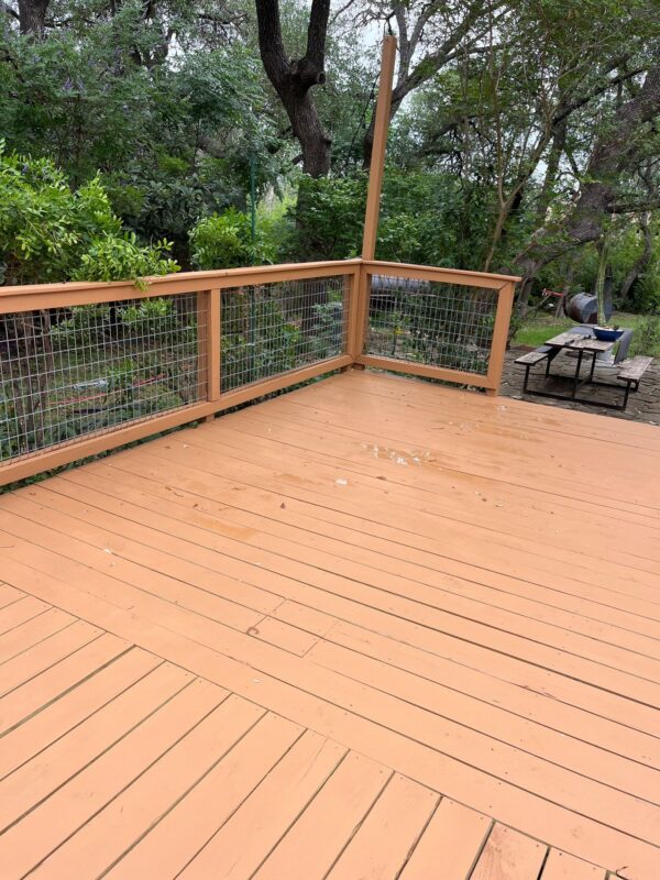 An outdoor deck with a light brown stain at a Texas home.
