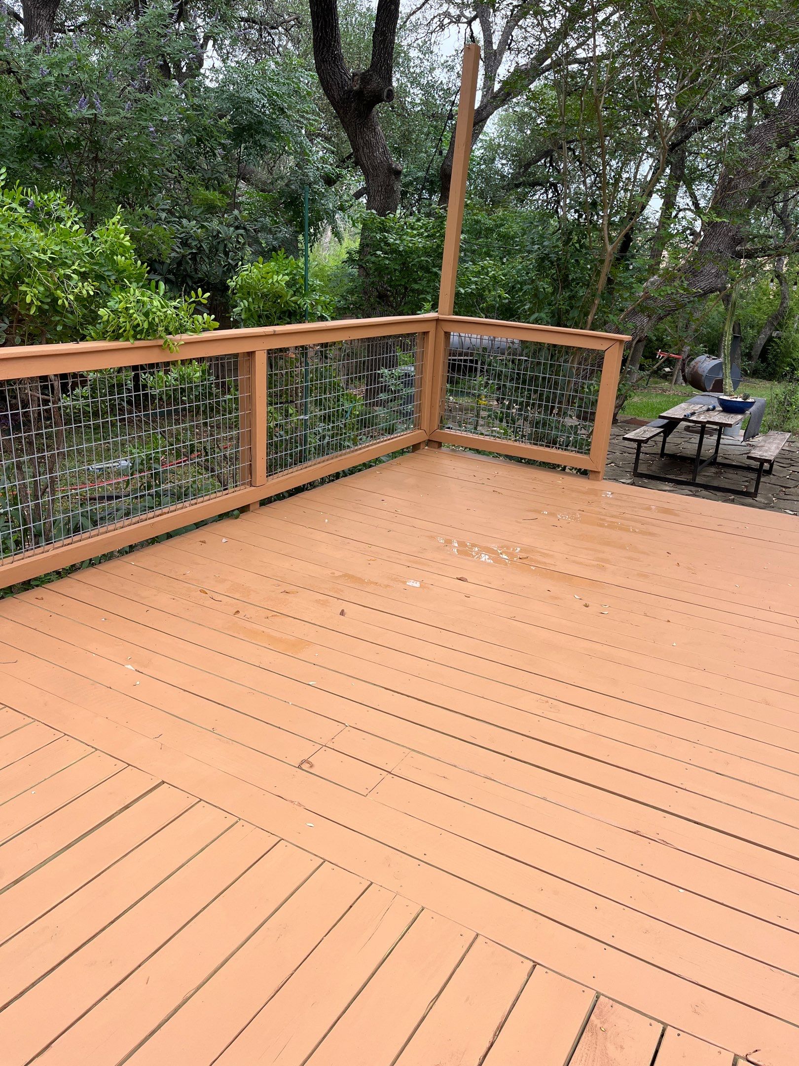 An outdoor deck with a light brown stain at a Texas home.